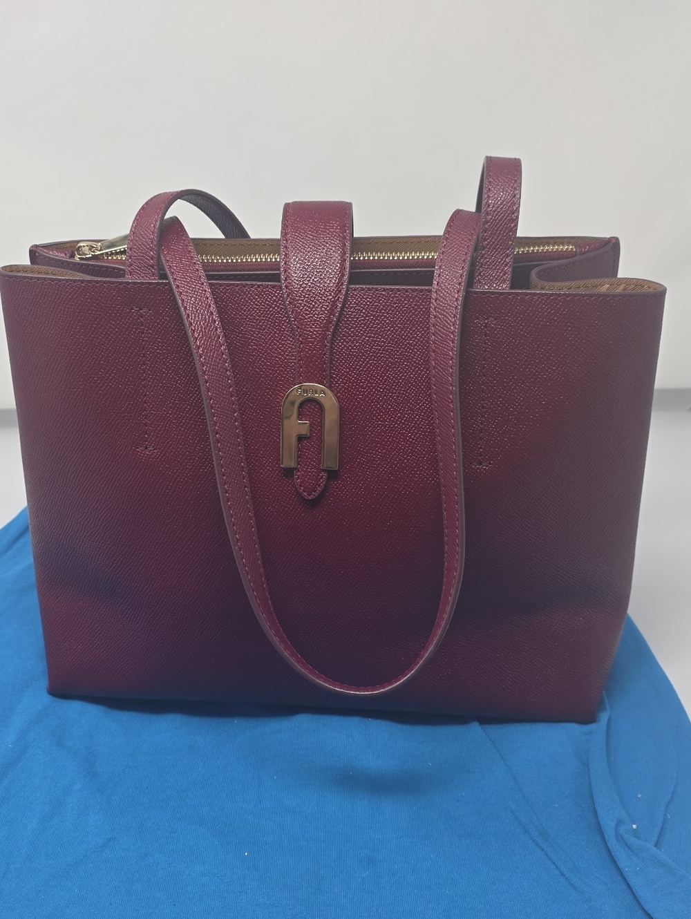 Furla Sofia Tote bag in a dark red color, featuring a textured leather finish